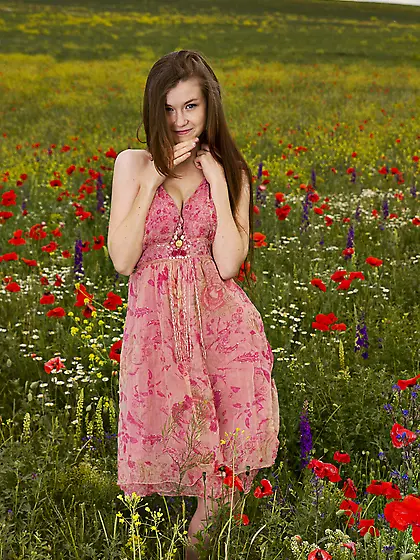 Pale-skinned brown-haired teen posing totally naked in a beautif