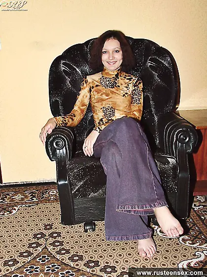 Teen brunette takes off pants and poses nude