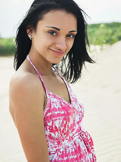 Exotic brunette has a playful time on sandy...