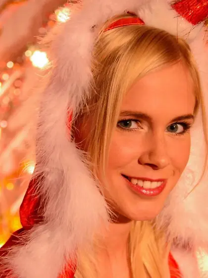 Blonde young woman in Snow Maiden's suit poses for fans on Chris
