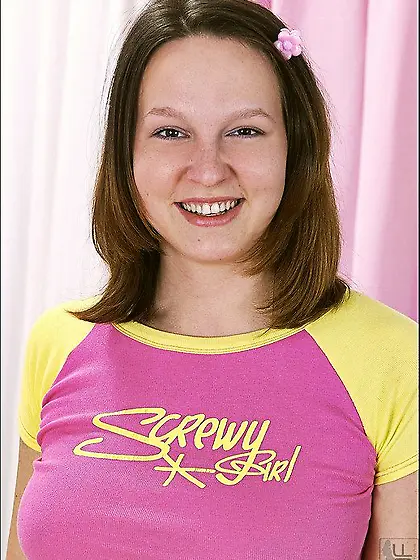 Playful teen babe Joann lifts her pink t-shirt then shows her ju