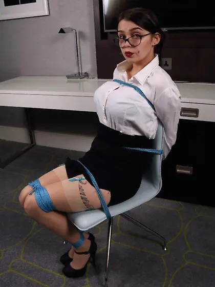 Tied up girl can't hide her huge hooters under the tight white s