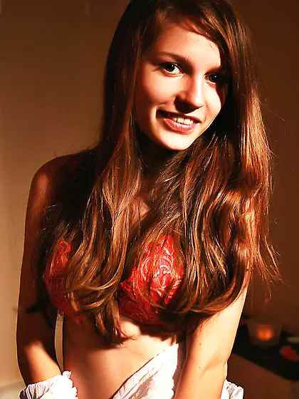 Redhead teen cutie dressed in red bathing half-naked in the dark