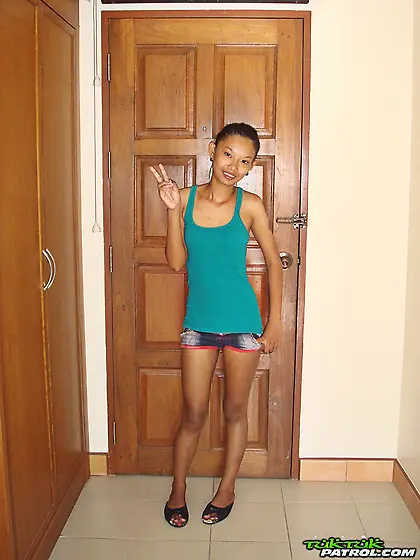 Skinny Asian girl is going to show nude body in a doorway