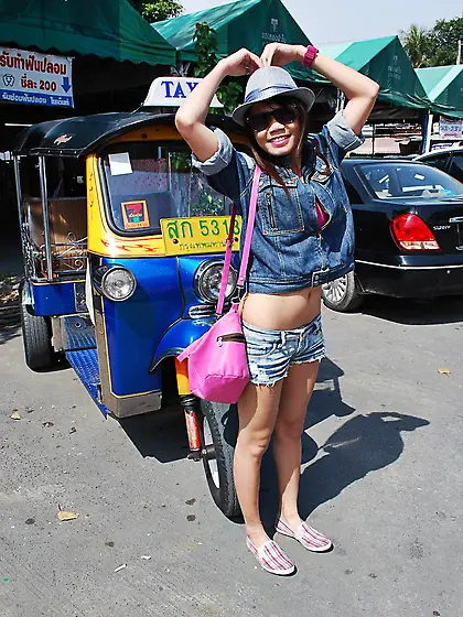 Joyful exotic teen agrees to pose with mature guy near auto rick