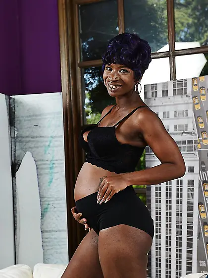 Pregnant black slut with saggy tits poses naked on camera and sh