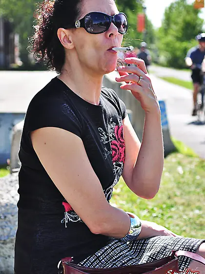 Redhead Mina in her sunglasses sexy smoking on a sunny day