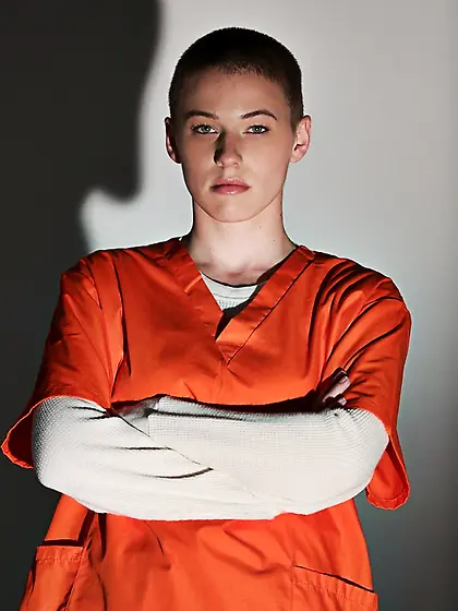 Short-haired prisoner undressing showing