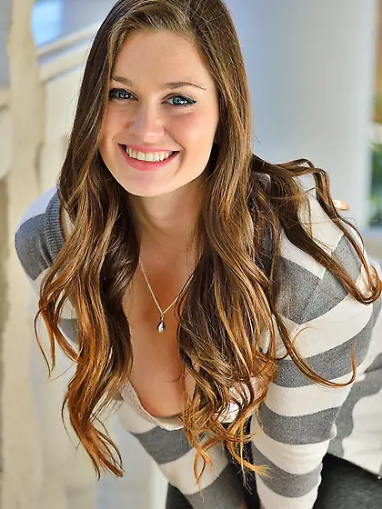 Brown-haired babe with a winning smile plays guitar with her tit