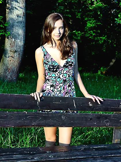 Oretha Mars shows her pussy outdoors on the grass.