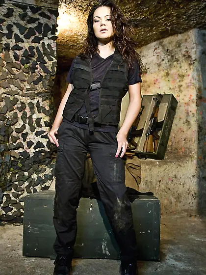 Small titted brunette with gun Pamela Ann takes off her black un