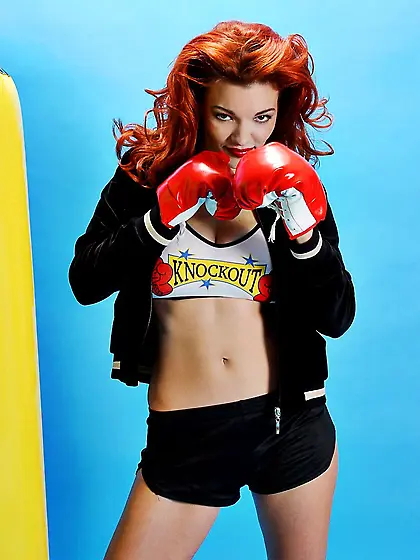 Tempting redhead Danielle Riley in black hot pants revealing the