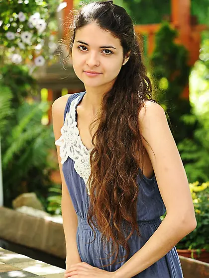 Brunette in a sexy dress shows her perky booty and trimmed pussy