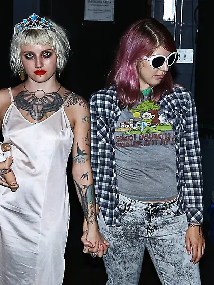 Girl is living it up at a rock concert and as singer comes close