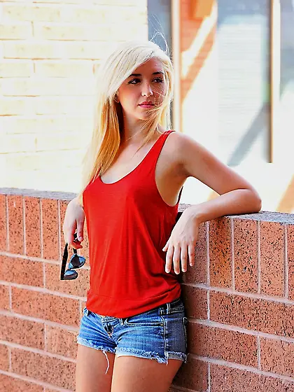 Young woman changes clothes to go playing volleyball in white st