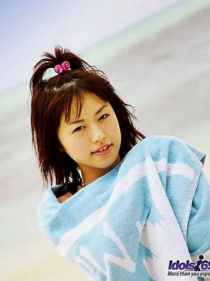 Smiling babe Hitomi Idols is playing tiny full back panty over h