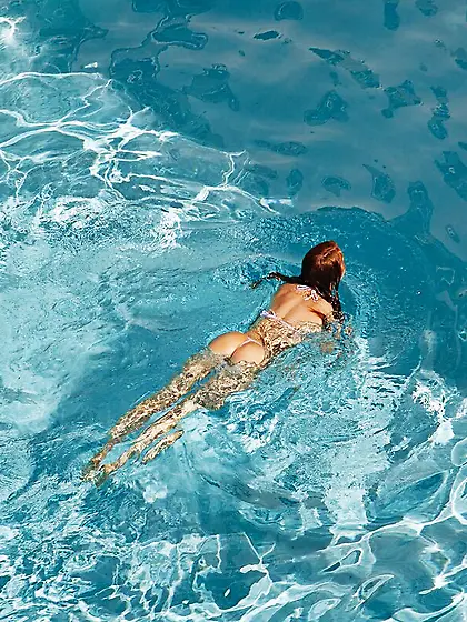 Teasing session by a ginger doll in a bikini