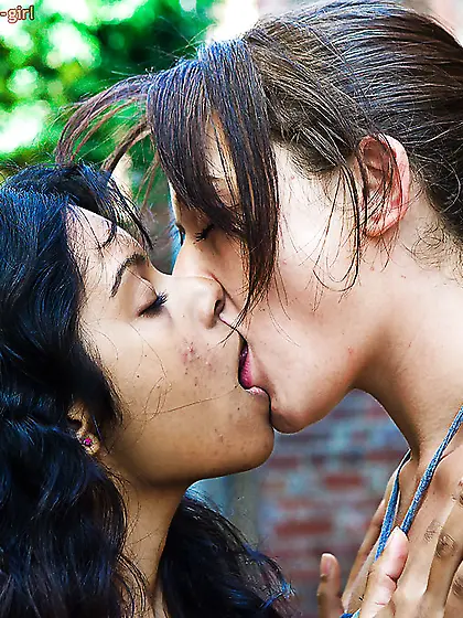 There are two lesbians on the outskirts of the city kissing and