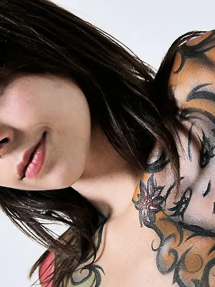 Ariel Rebel posing with her body full of fake tattooes and shows