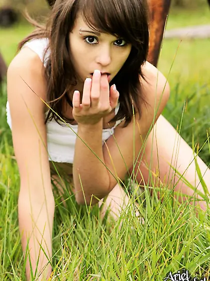 Ariel Rebel posing in hercute white shirt and shows her tiny tit