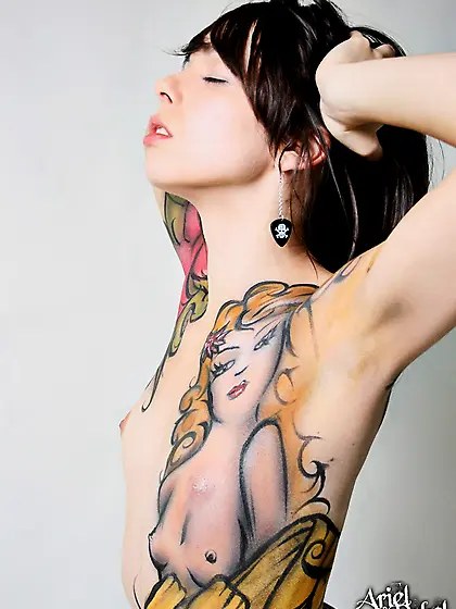 Horny babe,  Ariel Rebel posing with fake tattoos and shows her b