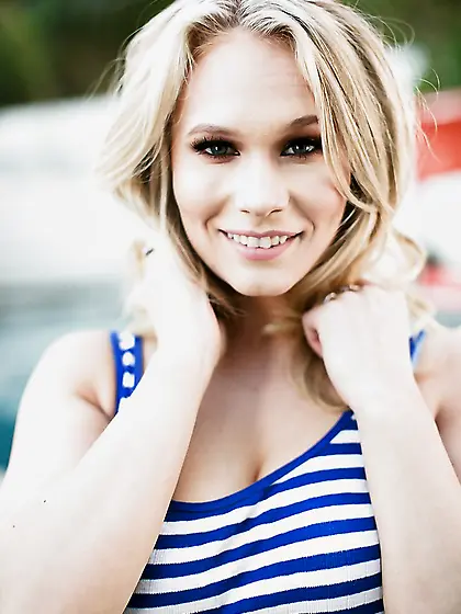 Lascivious young woman in a striped sailor top spreads her pussy