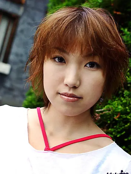 Cute looking Asian girl Madoka Ozava is lifting her top up uncov