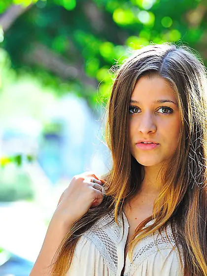 Playful brunette Teddi Rae is lifting skirt up and showing both