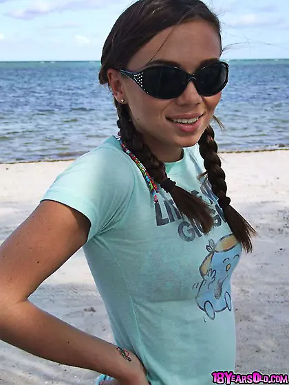 Teen wearing sunglasses comes to the beach where she is going to