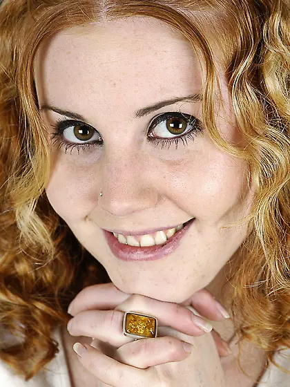 Curly playful chick Cherry Poppens gets completely naked to show