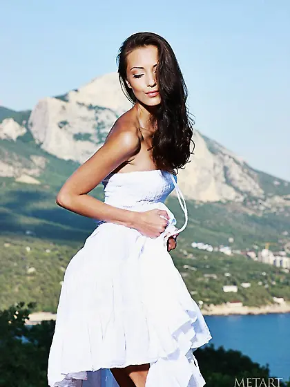 Fit brunette striking sexy poses on a hill with her boobs out Vi