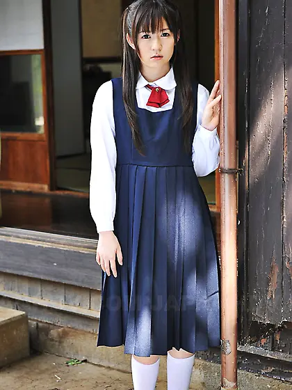 Innocent Japanese schoolgirl with beautiful eyes walks seductive