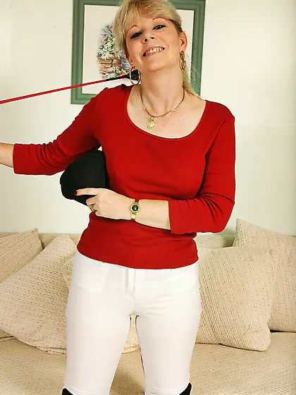 Fair-haired mature jockey woman Skye Hamil takes off her uniform