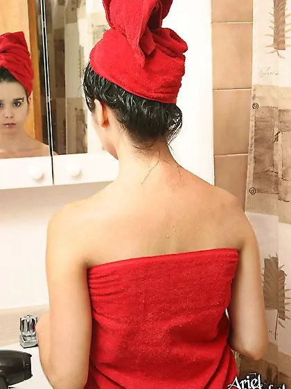 Ariel Rebel plays with a hairdryer while blowing dry her hair in