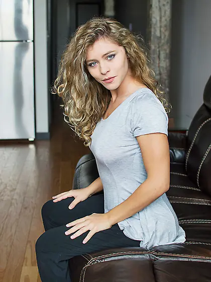 Young blonde candy strips naked and poses on the couch for the v