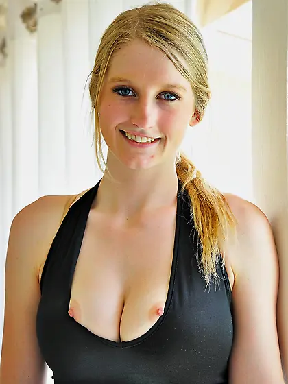 Fair-haired beauty in a black dress exposing her nips and pussy