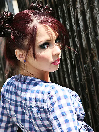 Redheaded teen enjoying two massive black cocks on a leather cou