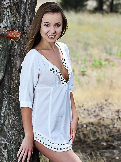 Natural teen comes to spacious forest to walk naked and with no