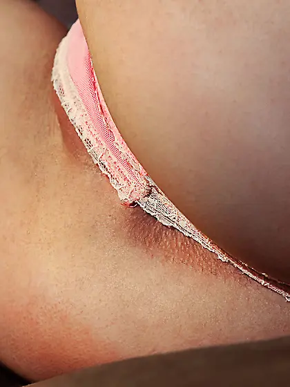 Curly-haired teen takes off her pale pink panties after playing