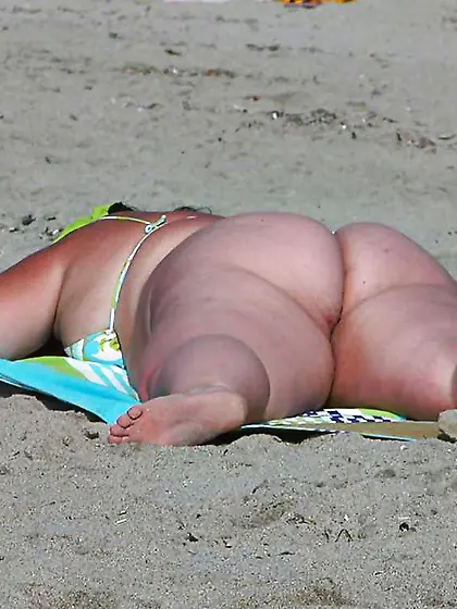 Large dolls on the beach.