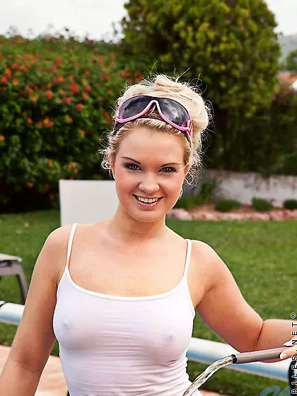 Cute foxy blonde Shelly Roberts strips by the pool and shows her