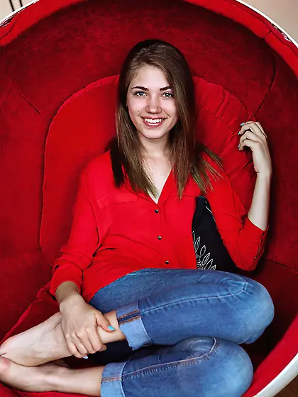 Young beauty with a radiant smile sensually stripping in an egg