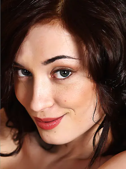 Handsome cute brunette Julie Vee is bending nude body on the arm