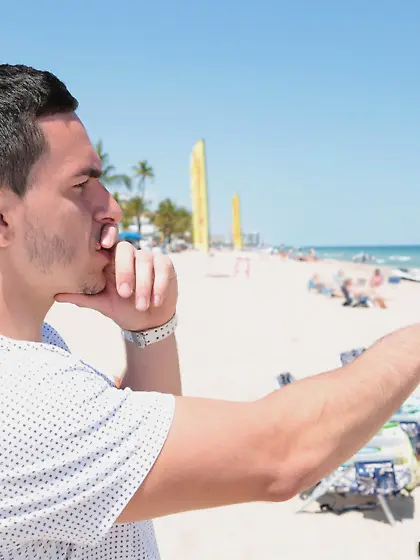 Thick brunette in a swimsuit gets seduced on a beach and fucked