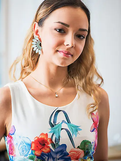 Busty blonde with wild hair organizing the flowers and showing h
