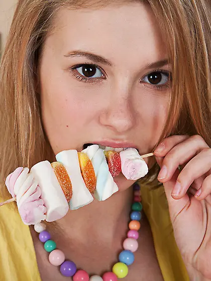 Luscious hottie eats marshmallows