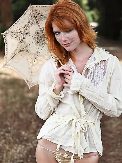 Ginger babe thinks nobody will see her naked under the umbrella