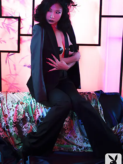 Wild Asian chick in black smokes a cigarette