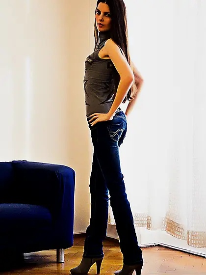 Lusty brunette chick Ilona Afterlife takes off jeans and top and