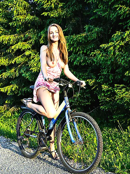 Bike-loving leggy beauty posing half-naked on the side of a road